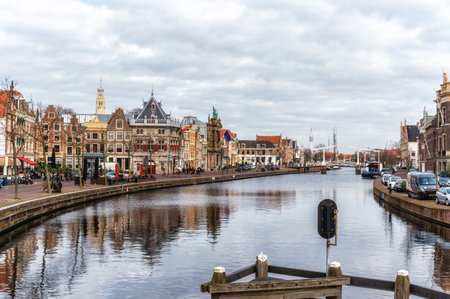 Spaarne river with row of old houses and weigh house in the city of Haarlem, Holland, Netherlandsの写真素材