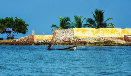Cartagena, Colombia - 21 March 2023: An artisanal fisherman in his duties on a canoe. Many locals work as such due to the traditional living that they opt to live.の写真素材