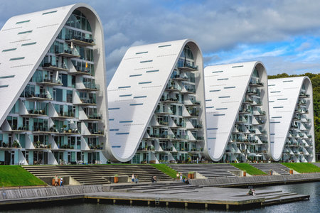 Low angle view of part of the residential building complex The Wave (Bolgen) inspired by Sydney Opera House and hilly landscape of Vejleのeditorial素材
