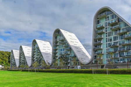 Low angle view of part of the residential building complex The Wave (Bolgen) inspired by Sydney Opera House and hilly landscape of Vejleのeditorial素材