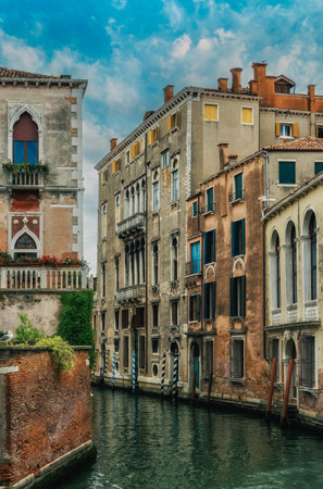 Perspective of venetian canal with moored boats, Venice, Italyの写真素材