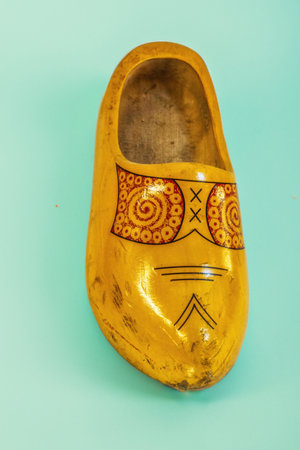 Traditional Dutch wooden clog isolated on a colored backgroundの写真素材
