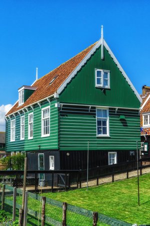 Walking on sunny spring day in small Dutch town Marken with wooden houses located on former island in North Holland, Netherlandsの写真素材