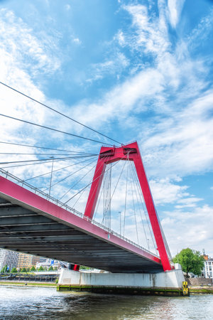 A view at the Willemsbrug, a cable-stayed red bridge with a total span of about 318 meters, Rotterdam, The Netherlandsの写真素材
