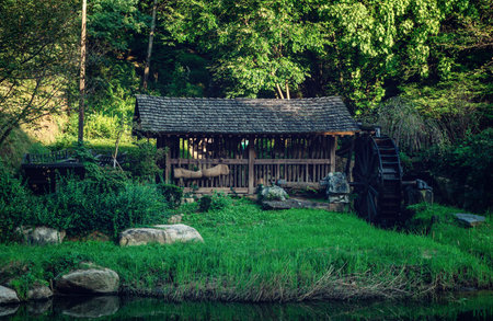 An old traditional watermill on a pond at the , Seoul, South Koreaの写真素材