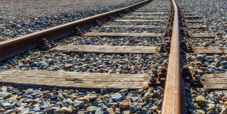Detail of railroad track with wooden railway ties and crushed stone for ballast, Netherlandsの写真素材