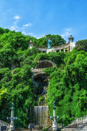 Saint Gellert with a cross on the Gellert Hill in front of Erzsebet bridge.の写真素材