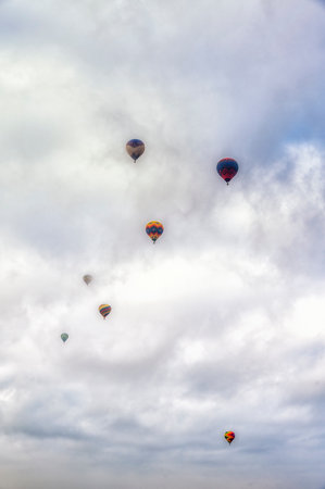 Spectacular view of hot air balloons flying over cloudy sky in Teotihuacan Mexicoの写真素材