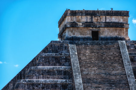 Mayan pyramid of Kukulcan against blue sky at Chichen Itza- Mexicoの写真素材