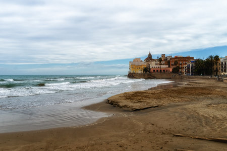 Beach with Sant Bartomeu i Santa Tecla church in Sitges, Catalunya, Spainの写真素材