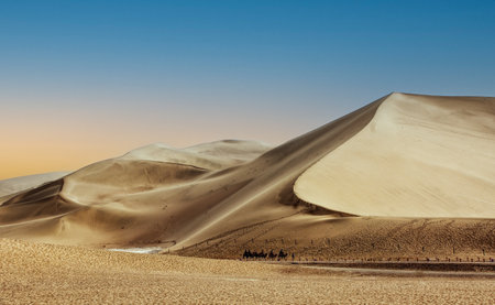 Camel riding on Mingsha mountain, Dunhuang, Gansu province, Chinaの写真素材