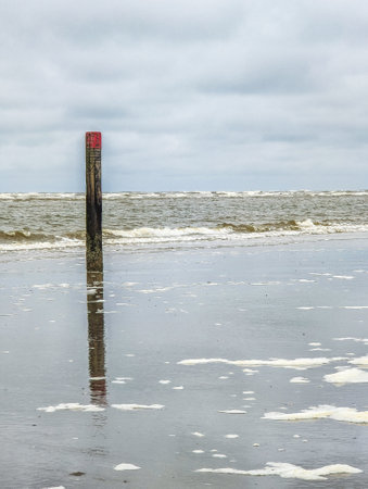 Beach pole in sand on West Frisian island Schiermonnikoog, Netherlandsの写真素材