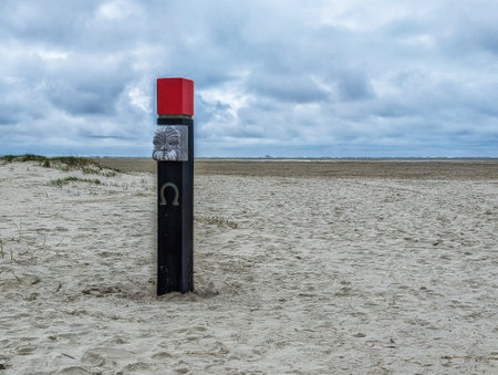 Beach pole in sand on West Frisian island Schiermonnikoog, Netherlandsの写真素材