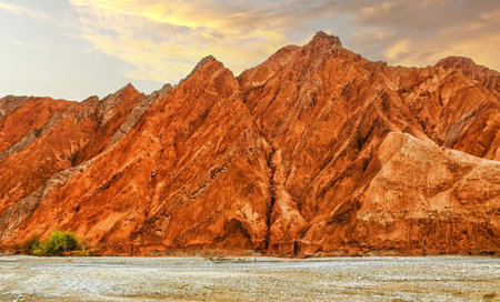 Rock formations, colorful mountains, eroded landscape and Gez river along Karakoram Highway, Xinjiang Autonomous Region, China.の写真素材
