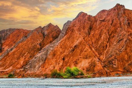 Rock formations, colorful mountains, eroded landscape and Gez river along Karakoram Highway, Xinjiang Autonomous Region, China.の写真素材