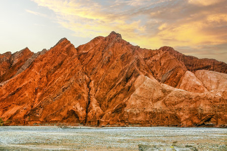Rock formations, colorful mountains, eroded landscape and Gez river along Karakoram Highway, Xinjiang Autonomous Region, China.の写真素材