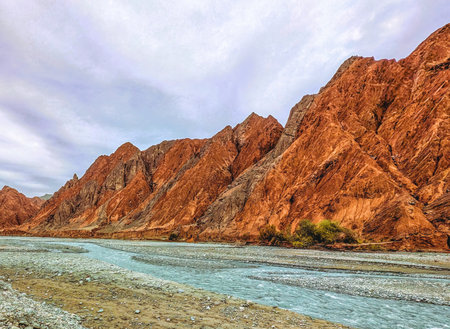 Rock formations, colorful mountains, eroded landscape and Gez river along Karakoram Highway, Xinjiang Autonomous Region, China.の写真素材