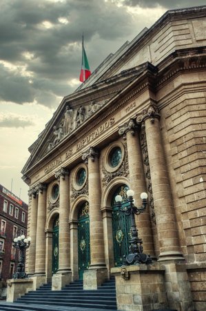 Ornate facade of the former seat of the senate, Camara de Dipurados, with green trim, Mexican flag flying above. Mexico City, Mexico.の写真素材