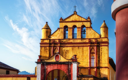 Yellow and red colonial style church in the town of San Cristobal de las Casas in Chiapas, Mexicoの写真素材