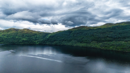 Beautiful Loch Lomond, Scotland, UK on a summer day showing water and mountains in a breath-taking...