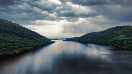 Beautiful Loch Lomond, Scotland, UK on a summer day showing water and mountains in a breath-taking...