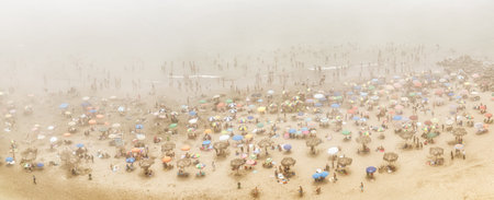 Lima, Peru- August 25th 2025 : Scenic misty view of a busy day on a beach in Miraflores