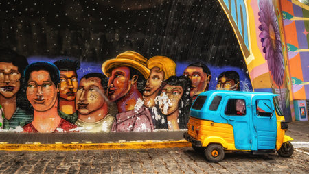 Lima, Peru- August 25th 2025 : A local tuc tuc passes a mural in the Barranco district of Lima.の写真素材
