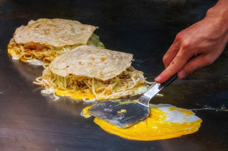 Okonomiyaki  is a Japanese savory pancake containing a variety of ingredients. The name is derived...