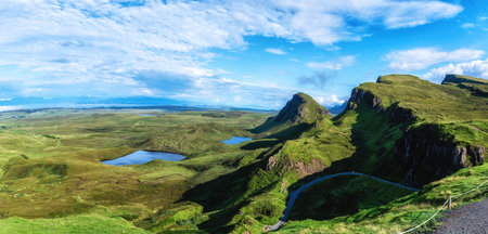 Scenic view at Quiraing in the  lush green highlands under a blue sky,  Majestic highland landscape,...