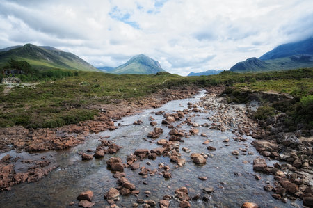 Scenic landscape view of the Black Cuillin mountains and stream at Sligachan on the Isle of Skye,...