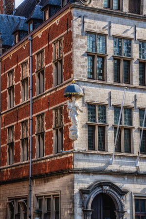 Sculpture of the Virgin Mary with the child, on the corner of a building on the Grote Markt, the main square of the city, Antwerp, Belgiumの写真素材