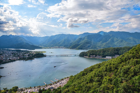 Scenic view from the Mount Tenjo Ropeway overlooking Lake Kawaguchi in Yamanashi Prefecture, Japan. The aerial perspective reveals the surrounding town and lush green hills, part of the Fuji Five Lakes region.の写真素材