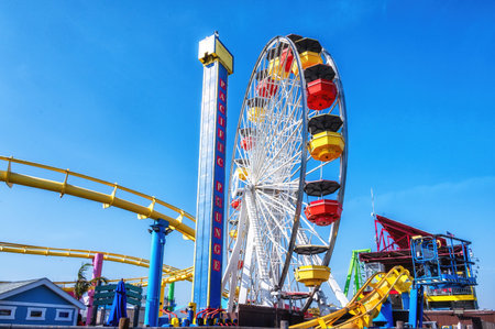Los Angeles, United States - 2 May 2026: Pacific Park amusement park on the Santa Monica Pier with the Ferris Wheel and the rollercoaster.
