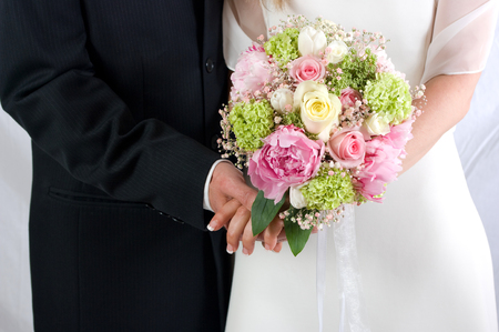 Wedding couple holding handsの写真素材