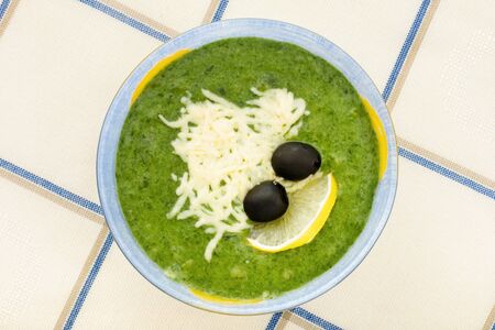 spinach soup, cheese, olives, lemonの写真素材