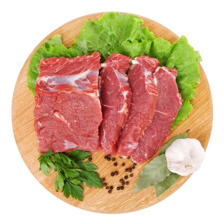 fresh raw beef steak meat on cutting board in closeup over white backgroundの写真素材