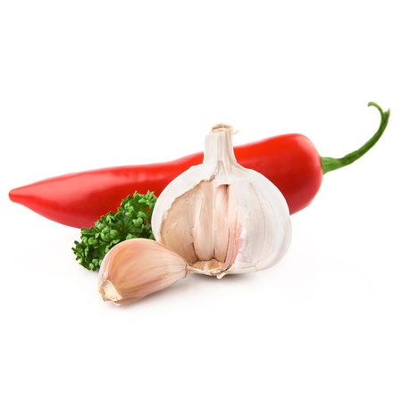 garlic & red pepper decorated parsley leaves isolated on white backgroundの写真素材