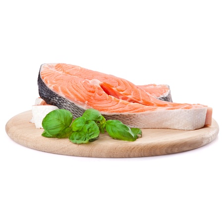 Salmon steak red fish decorated with basil on the kitchen board
の写真素材