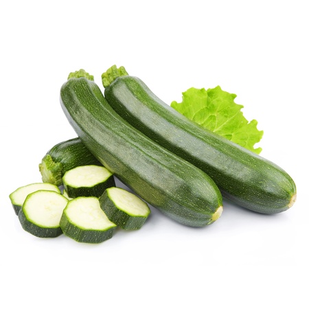 zucchini courgette decorated with green leaf lettuce. Isolated on whiteの写真素材