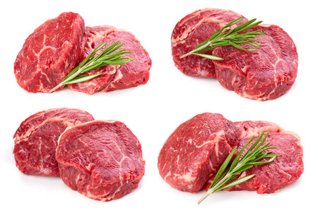 Fresh raw rib eye steaks isolated on white background. Beef steak with rosemary, sliced fresh meat.の写真素材