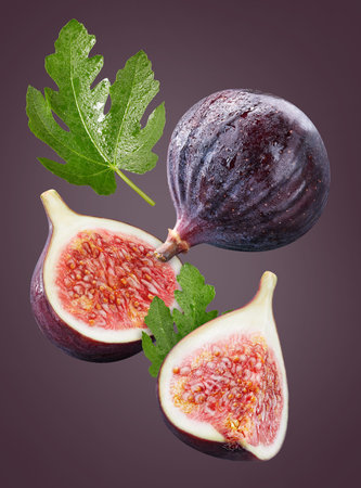 Flying ripe figs with green leaves isolated on white background. Fig collection with clipping path. Figs stack full depth of field macro shot.の写真素材