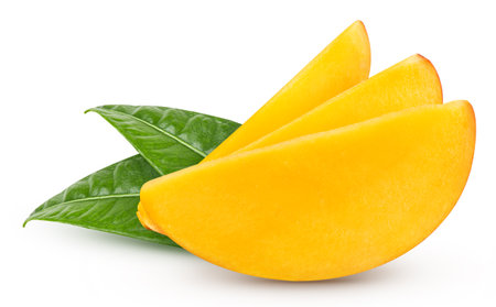 Mango fruit slices and mango leaves over whiteの写真素材