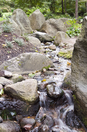 flowing water among the stonesの写真素材