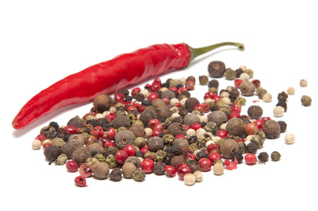 chili peppers and peppercorn on a white backgroundの写真素材