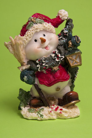 toy snowman on a green backgroundの写真素材
