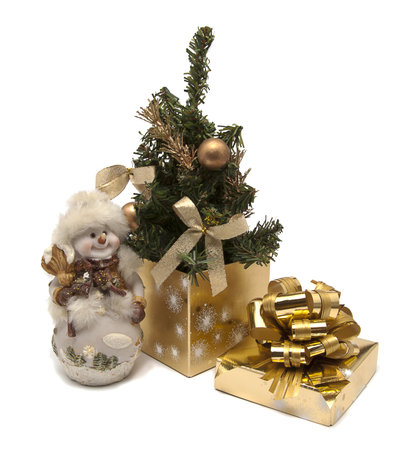 Christmas composition of christmas tree, present box and statueの写真素材