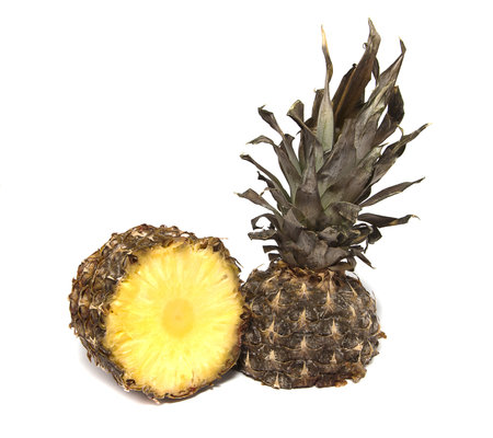 two halves of pineapple on a white backgroundの写真素材