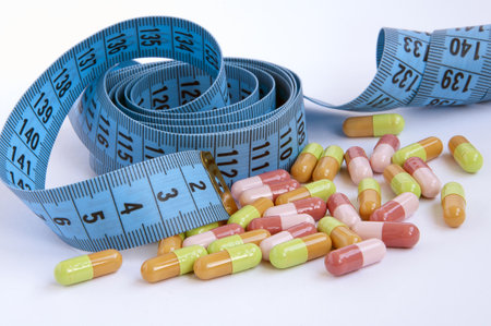 measuring tape with colored pillsの写真素材