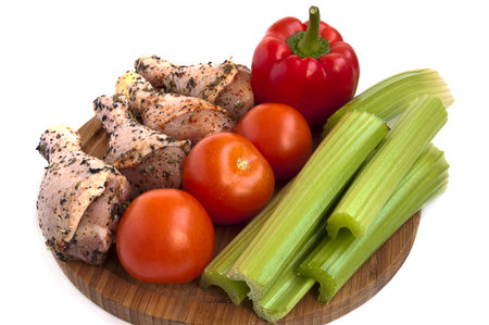 Marinated chicken legs with vegetablesの写真素材