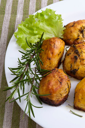 baked potatoes with rosemary and green saladの写真素材